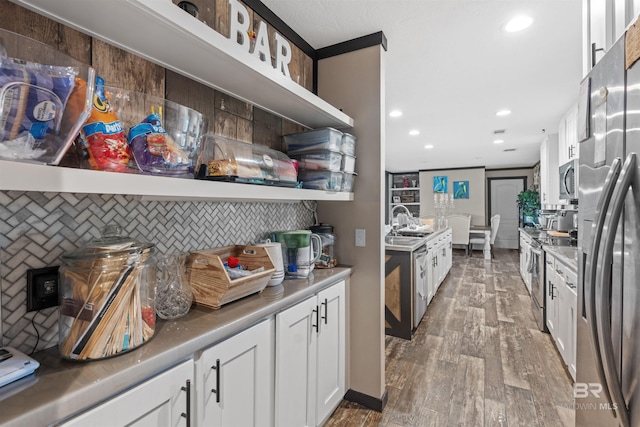 11691 Grantham Rd, Foley, AL 36535 - kitchen with stainless steel appliances, decorative backsplash, wood finished floors, white cabinets, and recessed lighting