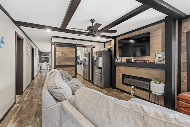 11691 Grantham Rd, Foley, AL 36535 - living room featuring a glass covered fireplace, wood finished floors, ceiling fan, a barn door, and beam ceiling