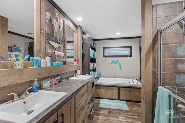 11691 Grantham Rd, Foley, AL 36535 - bathroom with crown molding, a garden tub, wood finished floors, double vanity, and a shower stall