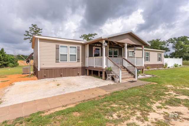 11691 Grantham Rd, Foley, AL 36535 - manufactured / mobile home featuring a porch and a front lawn