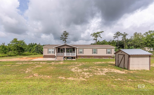 11691 Grantham Rd, Foley, AL 36535 - view of front of house featuring a shed, a front yard, and a porch