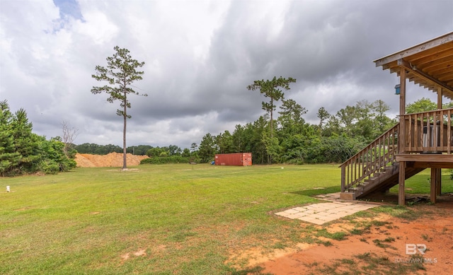 11691 Grantham Rd, Foley, AL 36535 - view of grassy yard featuring stairway, a wooden deck, and an outdoor structure