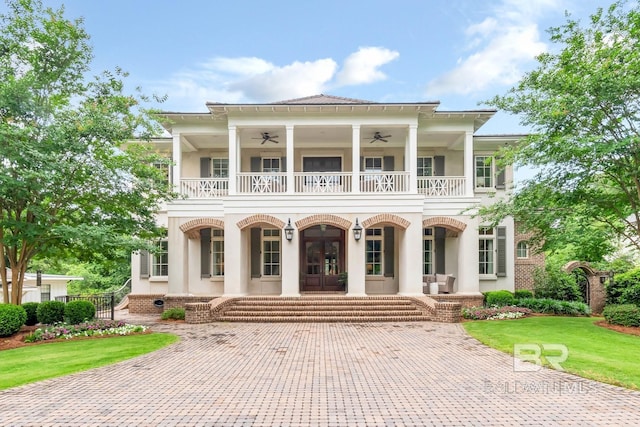 neoclassical / greek revival house with french doors, a porch, ceiling fan, a balcony, and a front lawn