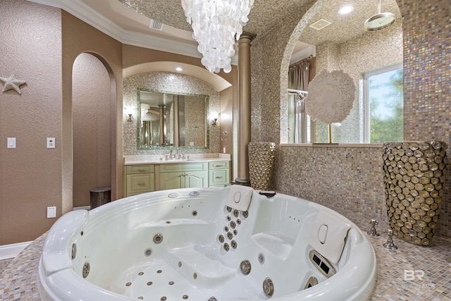 bathroom featuring a whirlpool tub, a textured wall, vanity, and crown molding