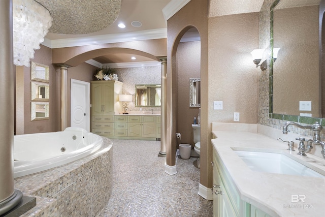 full bathroom with toilet, ornamental molding, a garden tub, vanity, and ornate columns