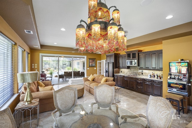 interior space featuring recessed lighting, visible vents, and an inviting chandelier