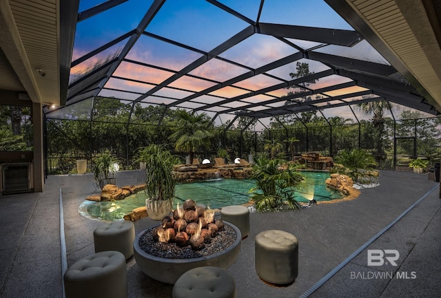 pool with a lanai and a patio area