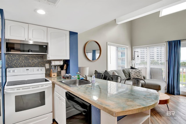 kitchen with black dishwasher, sink, kitchen peninsula, white cabinets, and white electric range