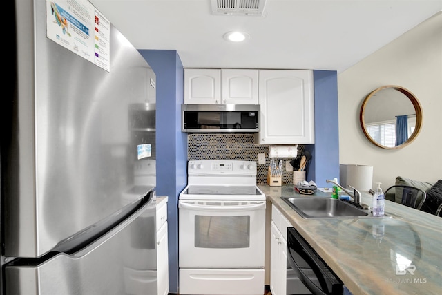 kitchen featuring visible vents, light countertops, white cabinetry, a sink, and stainless steel appliances