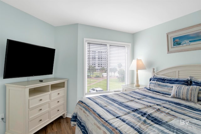 bedroom with dark hardwood / wood-style floors