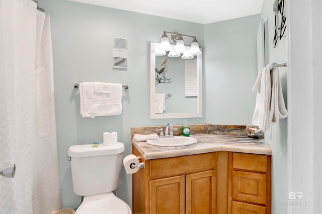 bathroom featuring vanity, toilet, and a shower with shower curtain