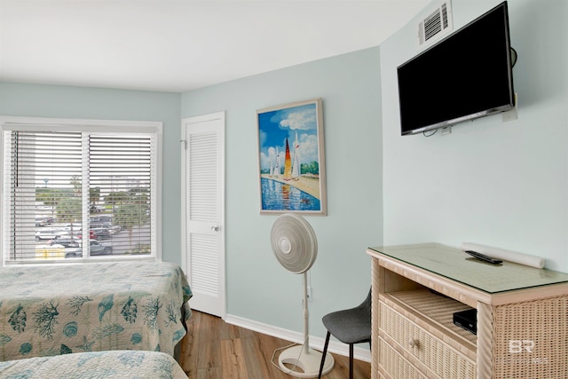 bedroom featuring a closet and hardwood / wood-style flooring