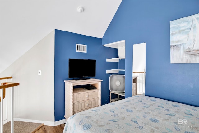 bedroom featuring vaulted ceiling and hardwood / wood-style floors