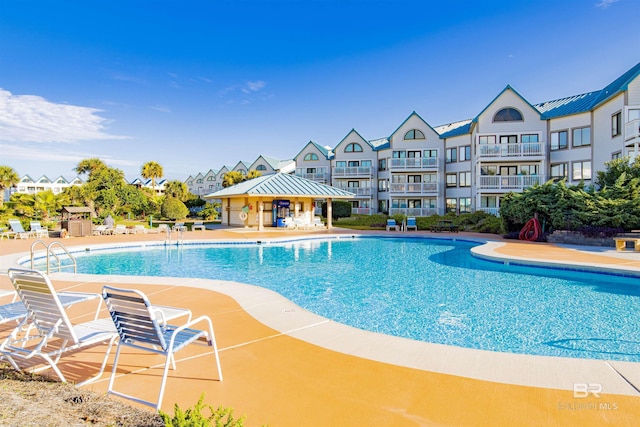 pool with a gazebo and a patio area