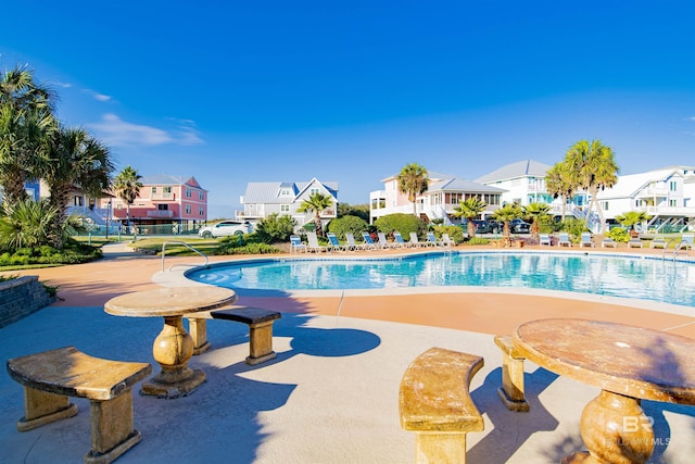 pool featuring a residential view and a patio area