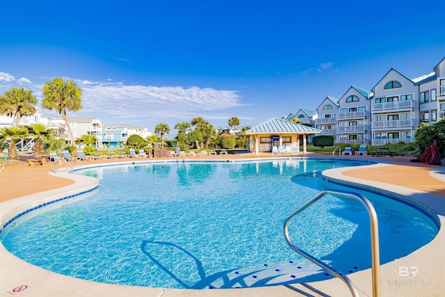 community pool featuring a gazebo and a patio area