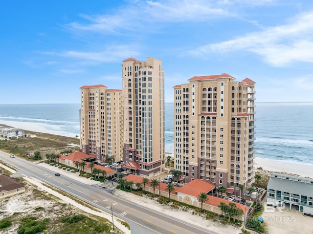 view of building exterior featuring a view of the beach and a water view