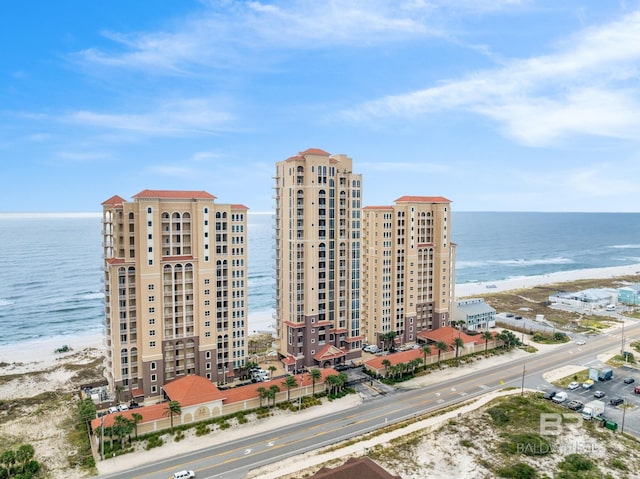 bird's eye view featuring a water view and a beach view