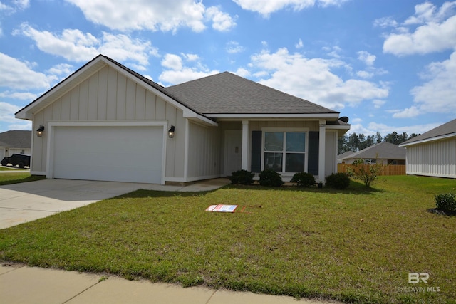 view of front of house featuring board and batten siding, roof with shingles, concrete driveway, a front yard, and a garage