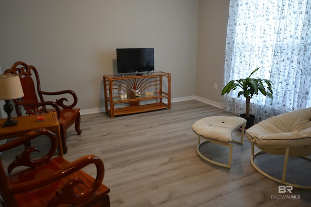 living area featuring wood finished floors and baseboards