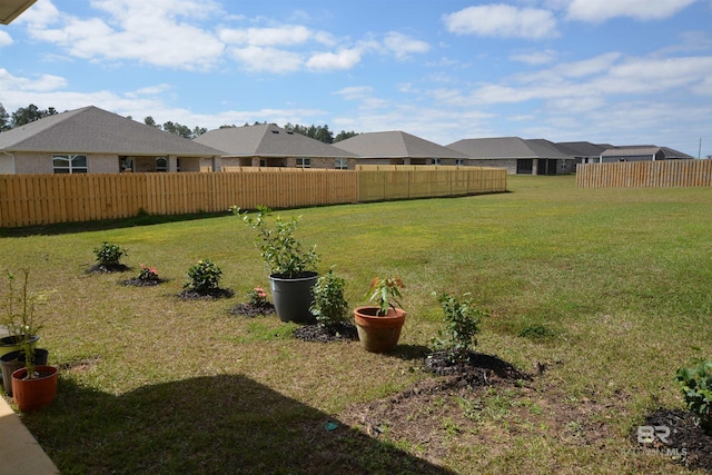 view of yard with a residential view and fence