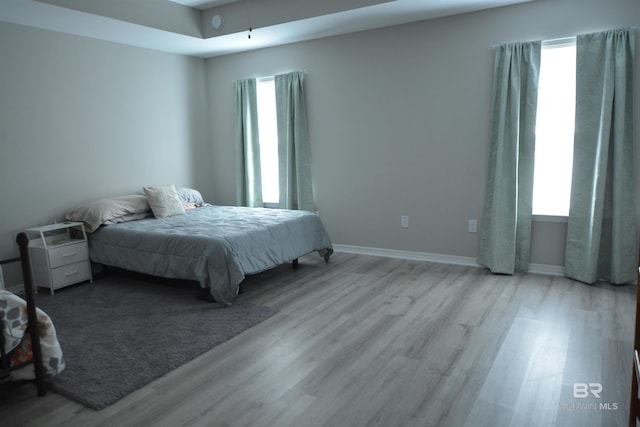 bedroom with baseboards and wood finished floors