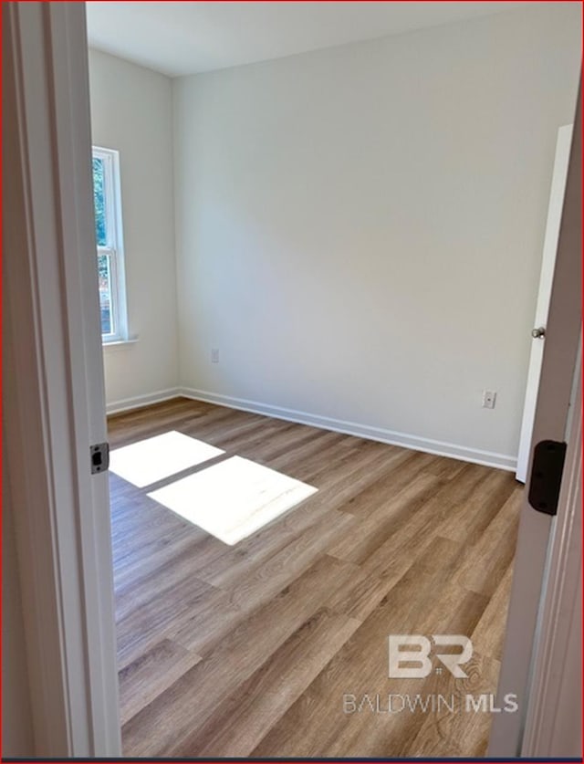 spare room with light hardwood / wood-style floors