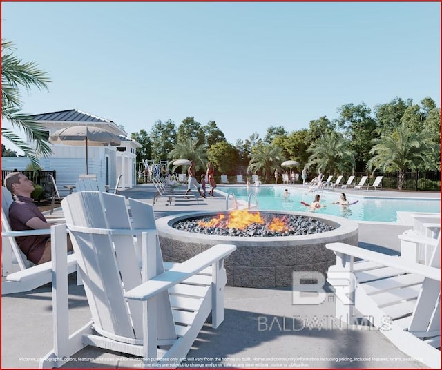 view of swimming pool featuring a fire pit