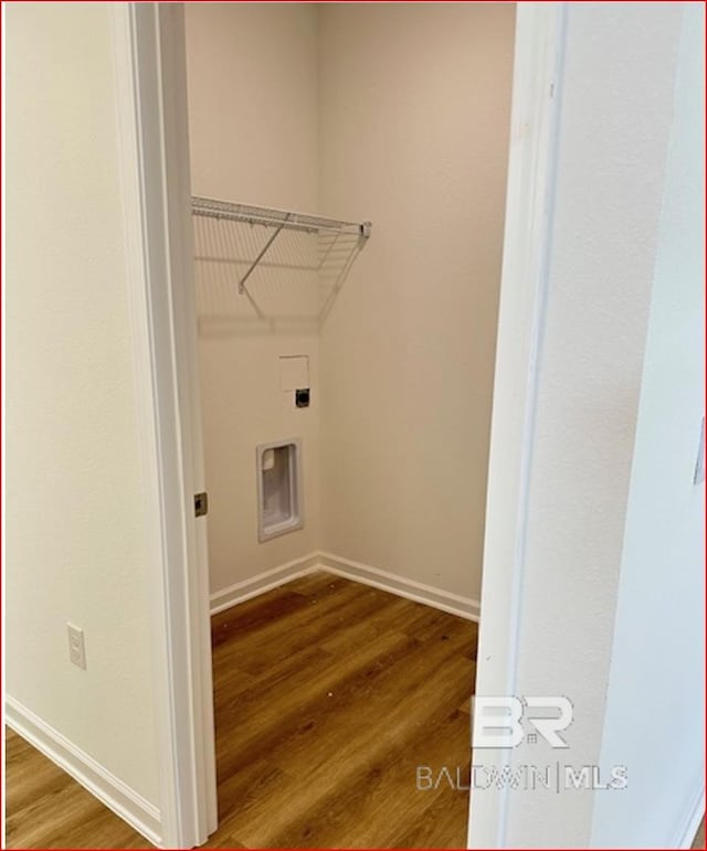 washroom with wood-type flooring and hookup for an electric dryer