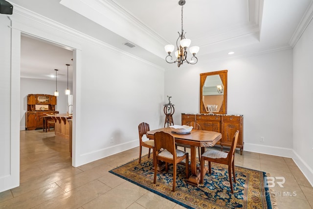 tiled dining area featuring an inviting chandelier, crown molding, and a tray ceiling