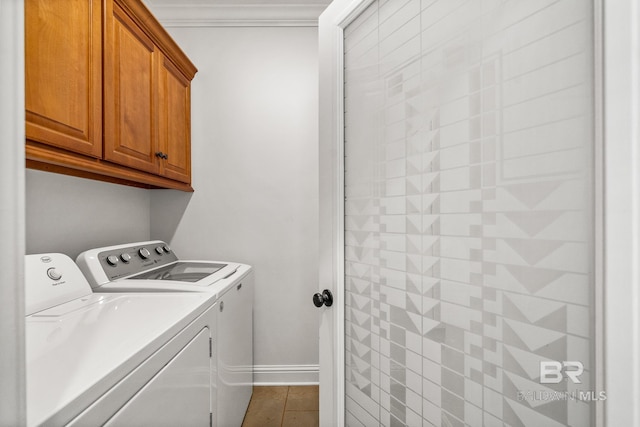 laundry area with crown molding, tile patterned floors, cabinets, and washing machine and clothes dryer