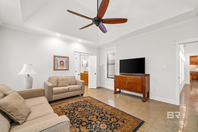 living room with ornamental molding, light tile patterned floors, and ceiling fan