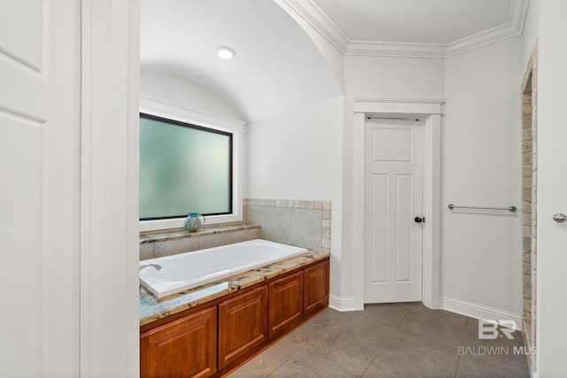 bathroom featuring a bathtub, tile patterned floors, and ornamental molding