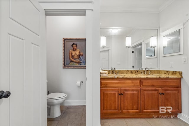 bathroom featuring toilet, crown molding, vanity, and tile patterned flooring