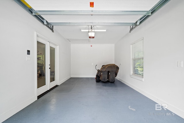 garage with a garage door opener and french doors