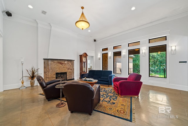 living room with ornamental molding and a premium fireplace