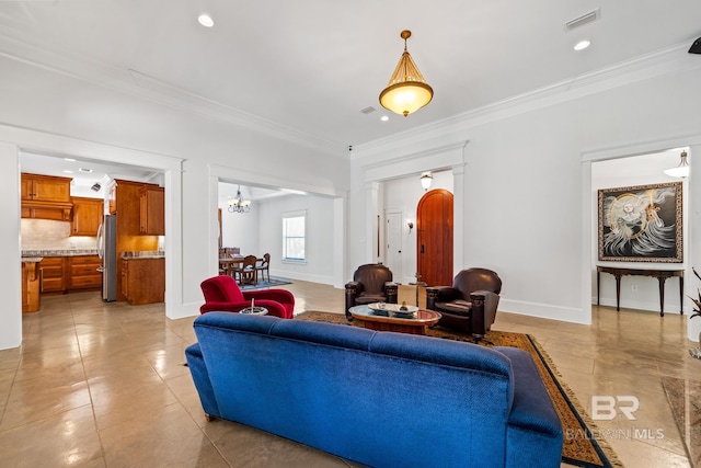 tiled living room featuring ornamental molding and a chandelier