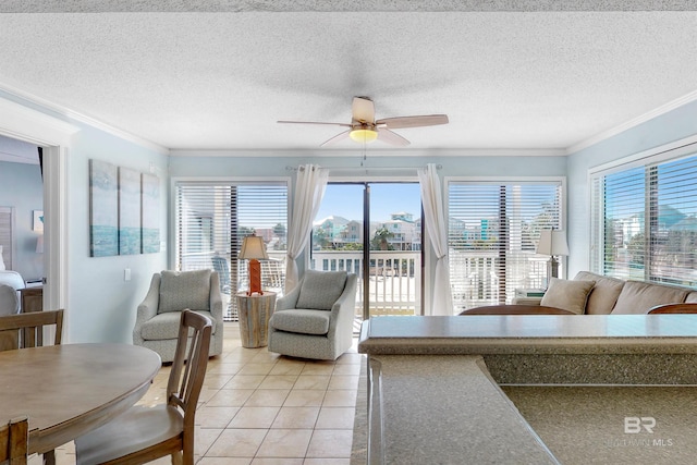 living room featuring light tile patterned floors, a textured ceiling, a wealth of natural light, and ceiling fan