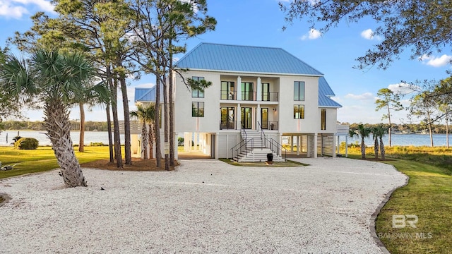 view of front facade featuring a balcony and a water view