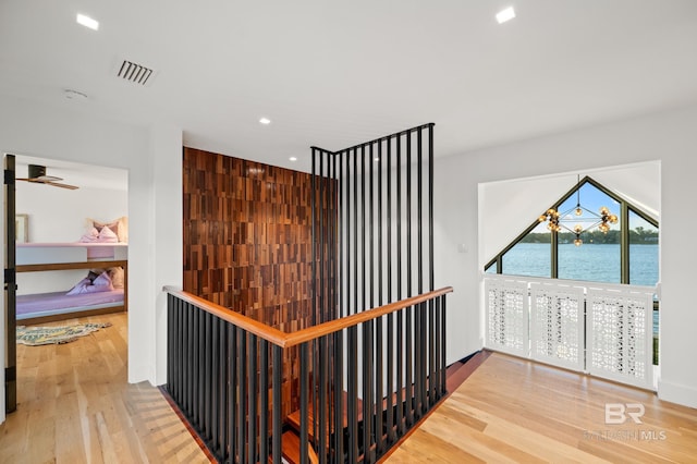 corridor featuring a water view and hardwood / wood-style flooring