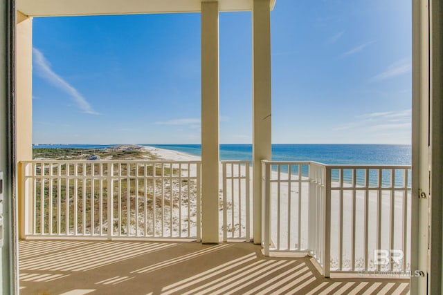 balcony with a beach view and a water view