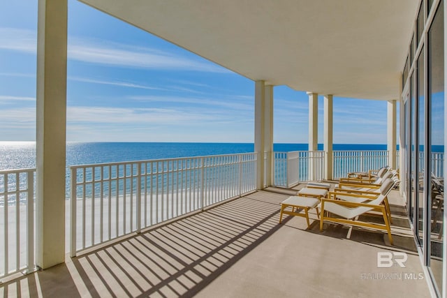 balcony with a view of the beach and a water view