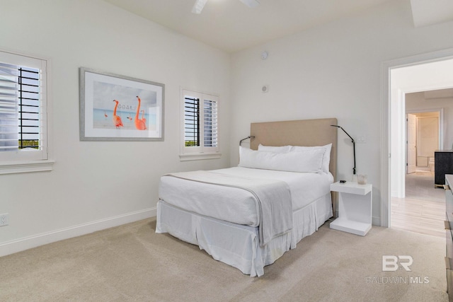 bedroom with multiple windows, light colored carpet, and ceiling fan