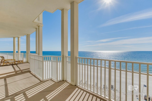 balcony with a view of the beach and a water view