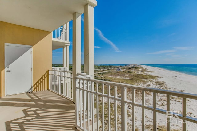 balcony with a water view and a beach view