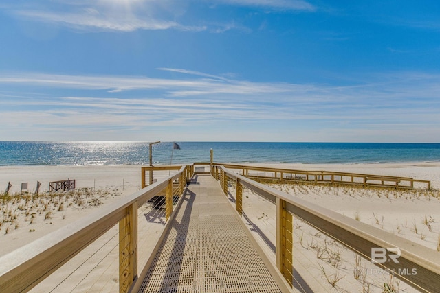 surrounding community with a view of the beach and a water view