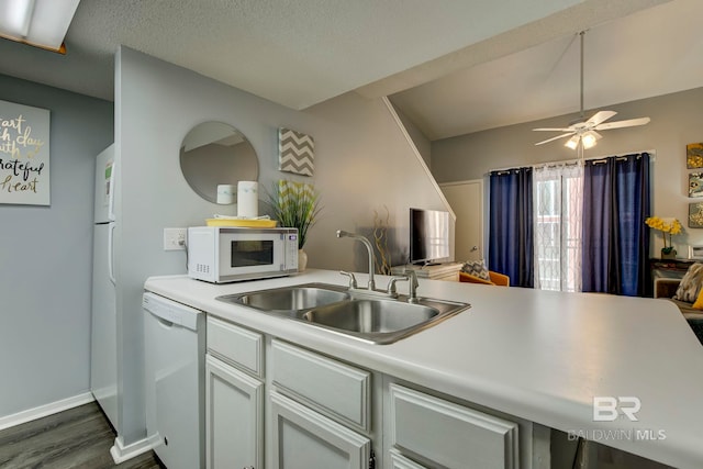 kitchen featuring a textured ceiling, sink, white appliances, dark hardwood / wood-style flooring, and ceiling fan