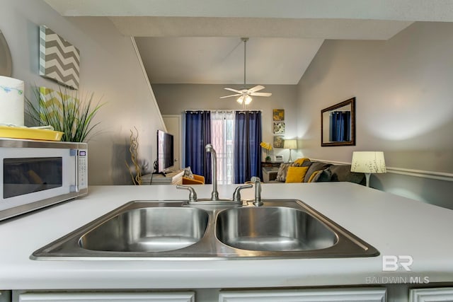 kitchen featuring lofted ceiling, sink, and ceiling fan