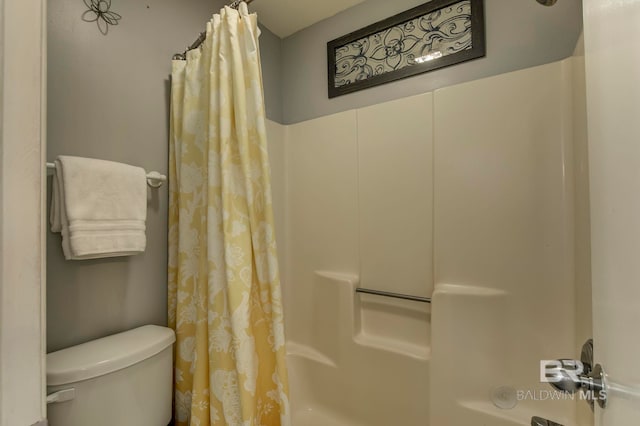 bathroom with shower / tub combo and toilet