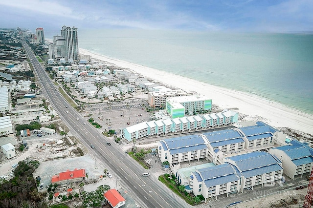 drone / aerial view with a water view and a beach view